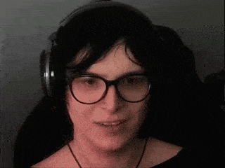 a woman wearing glasses and headphones has a surprised look on her face .