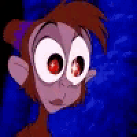 a close up of a monkey 's face with big red eyes .