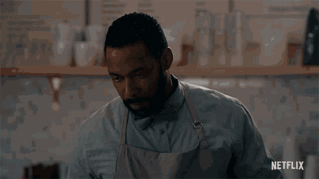 a man wearing an apron and a bow tie is standing in front of a netflix logo