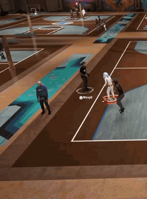 a group of people are playing a game of basketball and one of the players is named waxyli