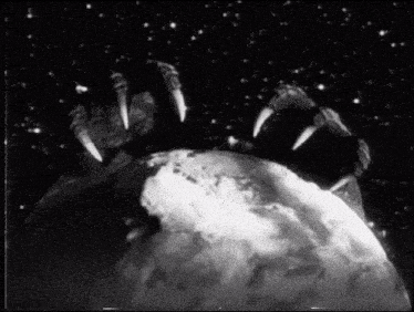 a black and white photo of a monster 's claws reaching out towards the earth