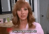a woman with red hair is standing in a bathroom and saying `` i do not endorse it '' .