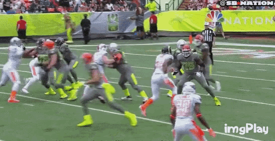 a football game is being played on a field with a sign that says imgplay