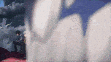 a blurry picture of a man sitting in front of a wall with the word ' tokyo ghoul ' on the bottom