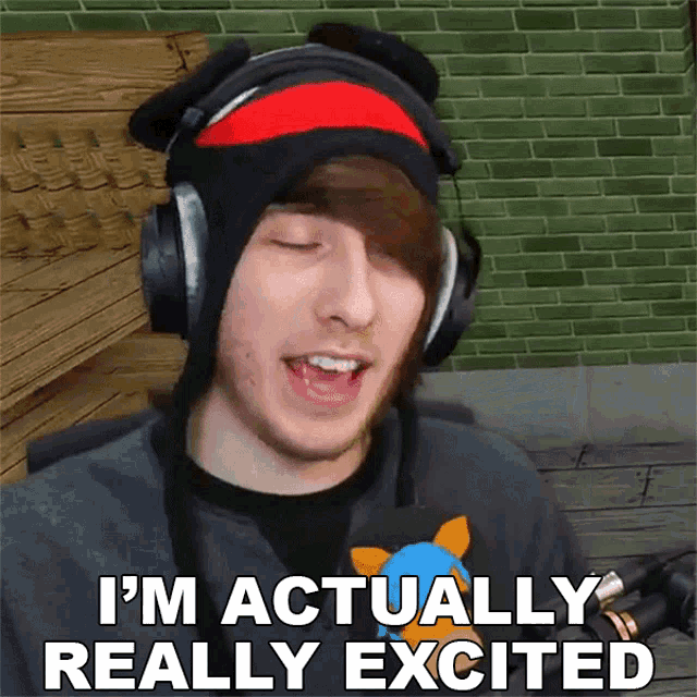 a young man wearing headphones and a hat says i 'm actually really excited