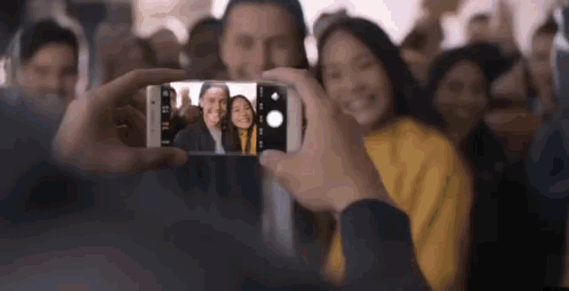 a man is taking a picture of a group of people
