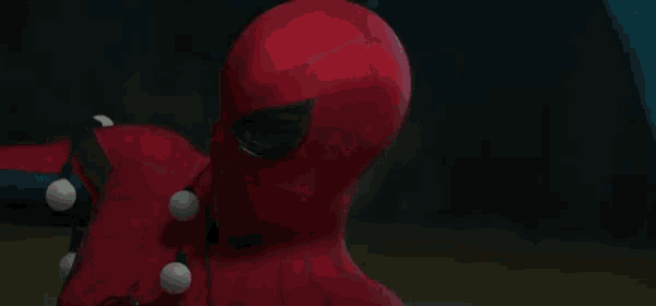 a close up of a spider man 's face with a blurred background