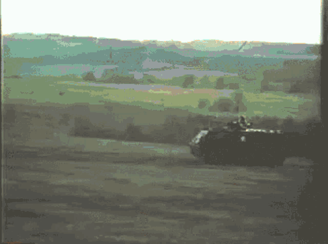 a pixelated image of a tank driving down a dirt road