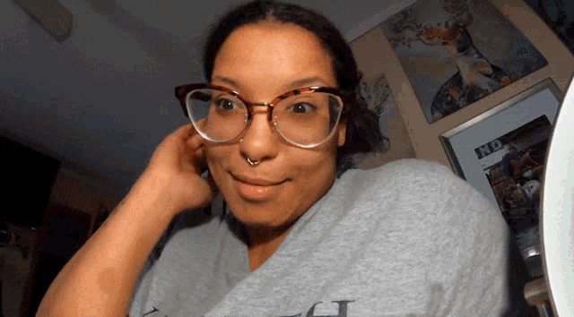 a woman wearing glasses and a gray shirt that says fox