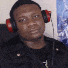 a man wearing red headphones is looking at the camera