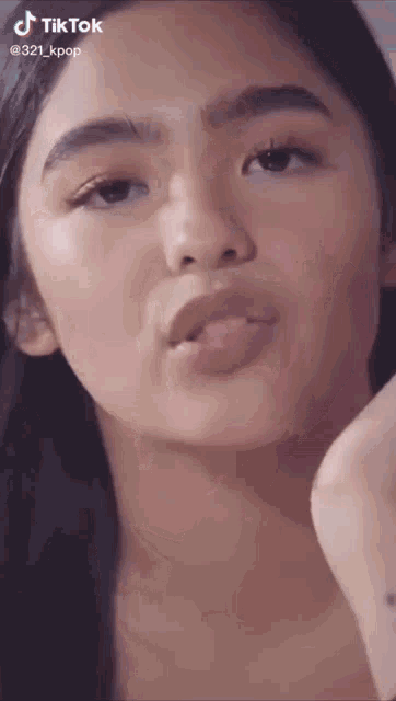 a close up of a woman 's face with a tiktok logo on the bottom