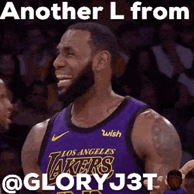 lebron james is wearing a purple lakers jersey and smiling during a game .