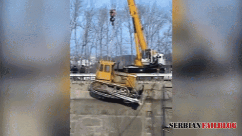 a yellow bulldozer is being lifted by a crane with the serbian failblog written below it