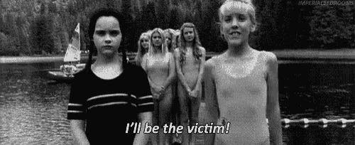 a group of young girls are standing next to each other on a lake .
