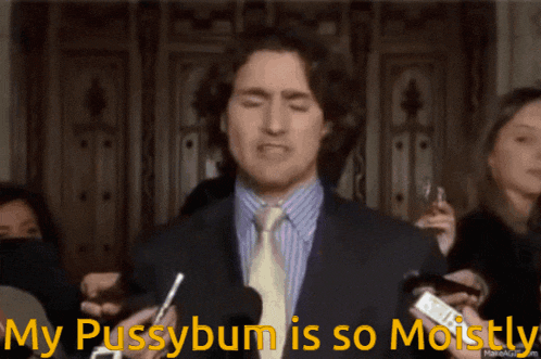 a man in a suit and tie stands in front of microphones with the words my pussybum is so moistly above him