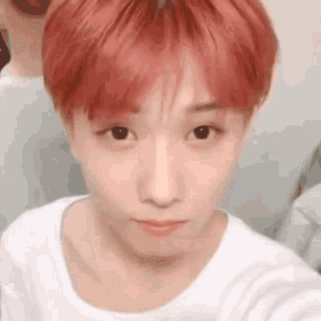 a close up of a person taking a selfie with their red hair .