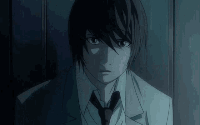 a close up of a person 's face with a suit and tie