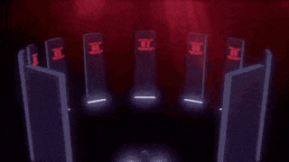 a group of doors with red lights on them in a dark room with a red background .