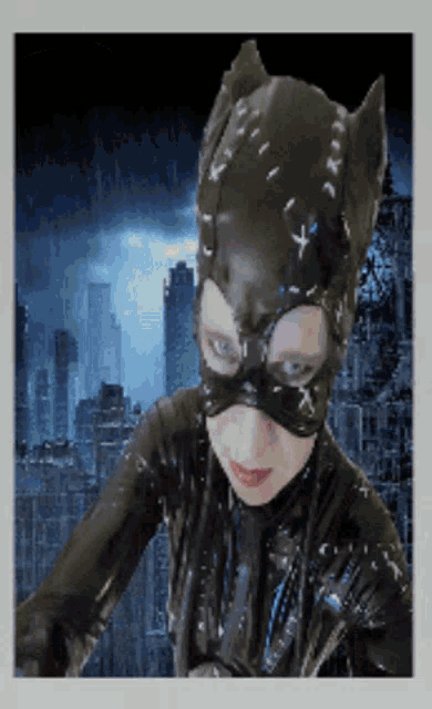 a girl in a catwoman costume stands in front of a city