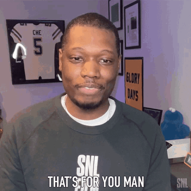 a man wearing a black snl sweatshirt says that 's for you man