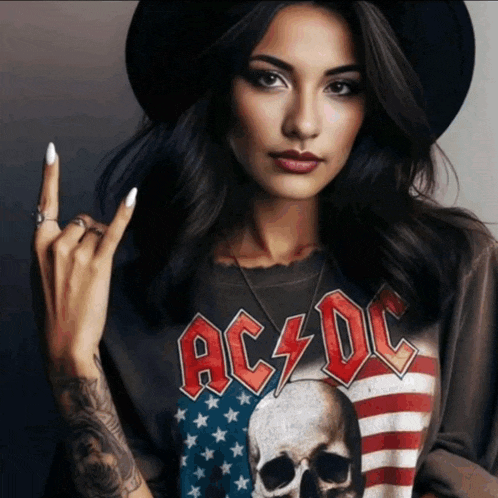 a woman wearing a shirt that says ac dc is making a rock sign