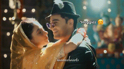 a man in a hat is holding a woman in his arms while they are dancing .