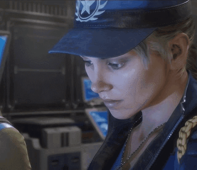 a woman wearing a blue hat and a necklace looks to the side