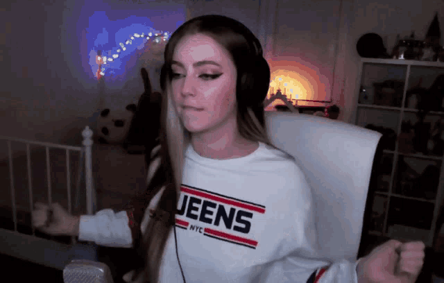 a woman wearing headphones and a jeens nyc sweater
