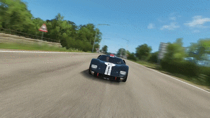 a blue race car with the letter t on the side