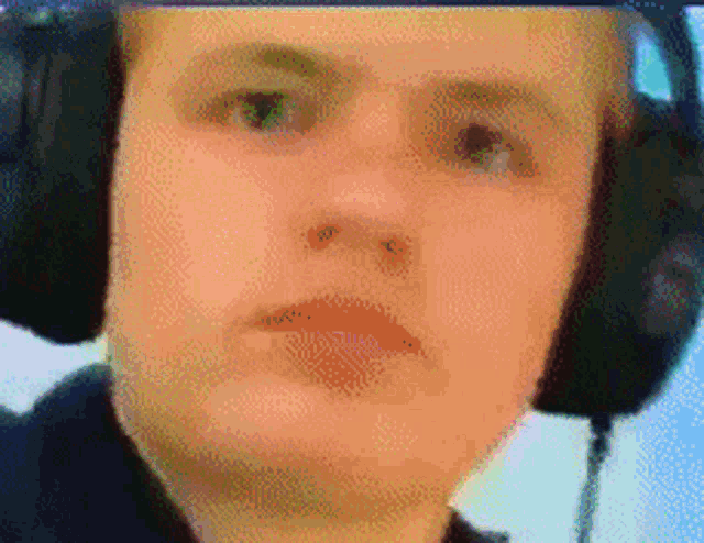 a man wearing headphones looks at the camera
