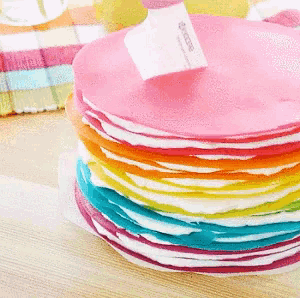 a stack of rainbow colored plates with a kyocera logo on top
