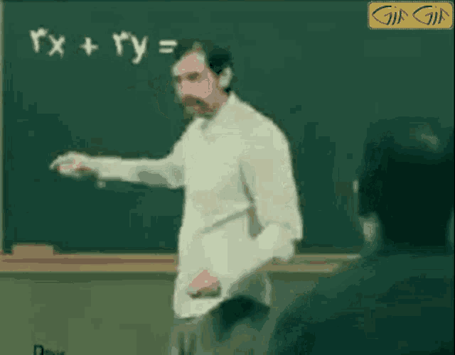 a man stands in front of a blackboard with a mathematical equation on it