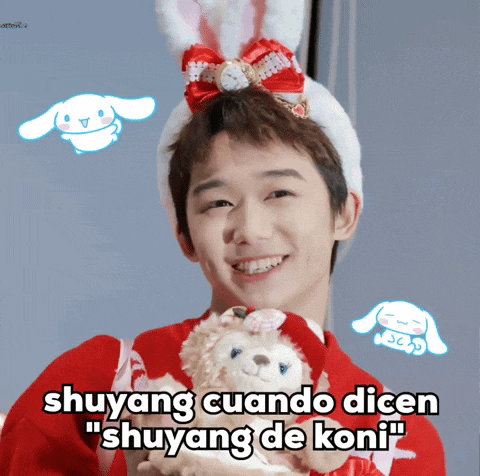 a boy wearing a bunny hat is holding a stuffed animal with the caption " shuyang cuando dicen "