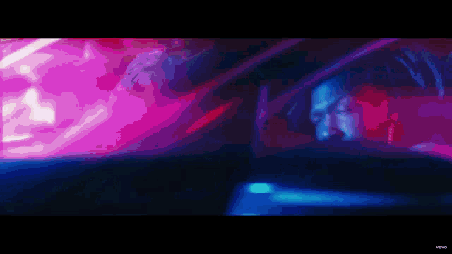 a blurry picture of a person driving a car in a dark room
