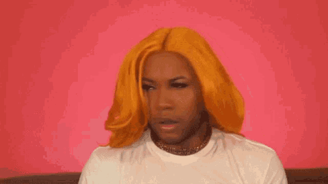a man with long orange hair is wearing a white shirt and a choker .
