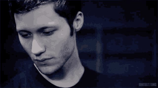 a man 's face is shown in a black and white photo with the word unarating written below it