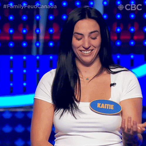 a woman wearing a name tag that says katie on it