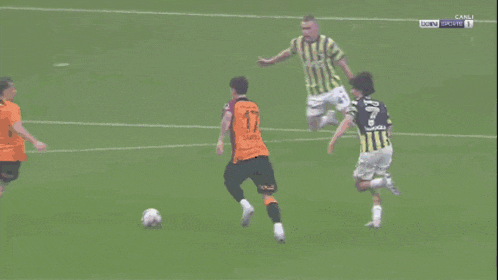 a soccer goalie makes a save in front of a medical park banner