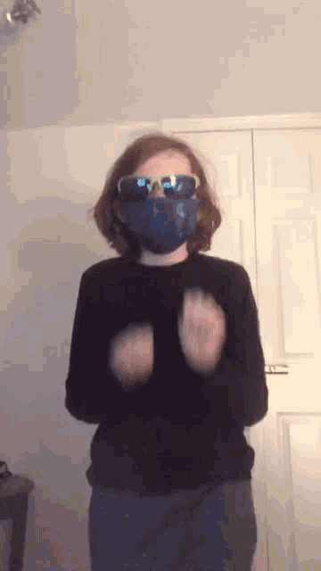a person wearing a blue mask and sunglasses is standing in front of a door