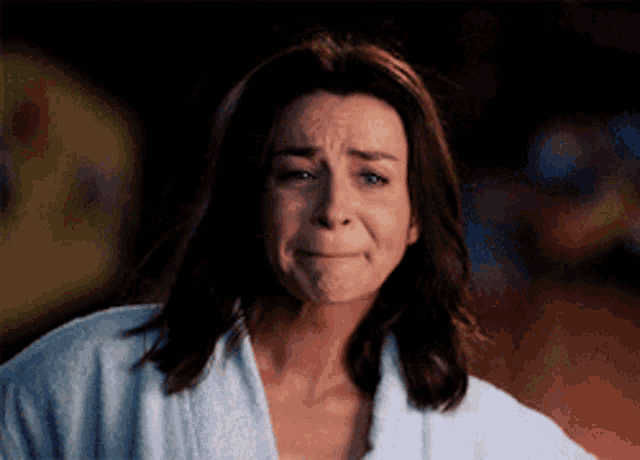 a woman wearing a white robe is crying