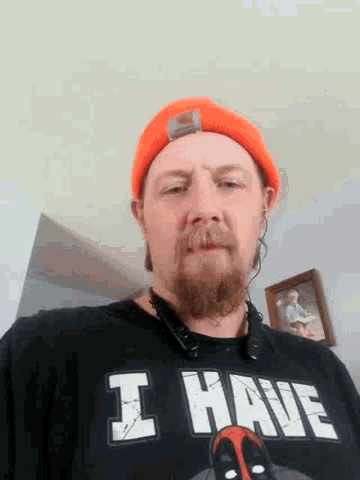 a man with a beard wearing a black shirt that says i ame
