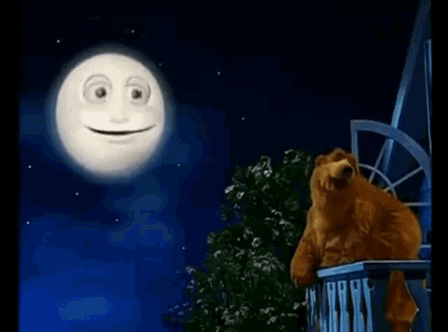 a teddy bear is sitting on a balcony looking at a smiling moon .