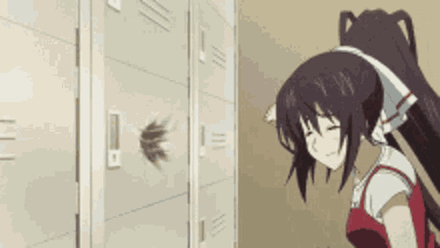 a girl with long hair is standing in front of a locker