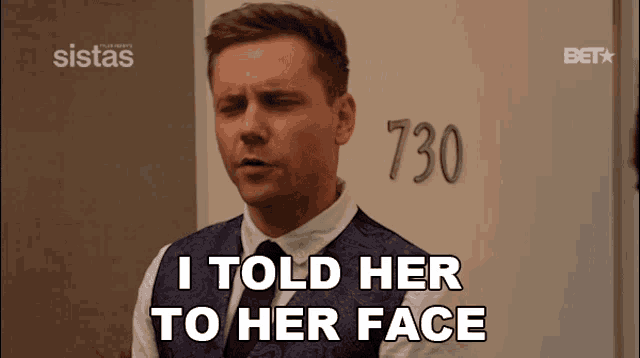 a man standing in front of a sign that says 730