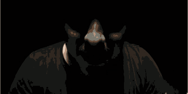 a man with a beard is making a face in the dark