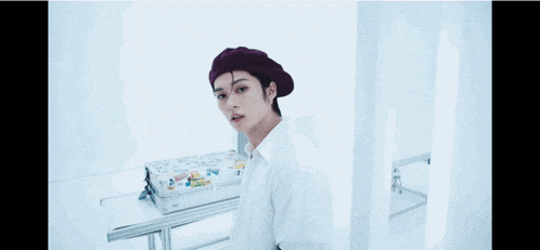 a woman wearing a purple beret and a white shirt