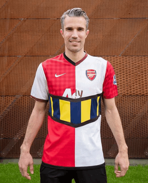a man is wearing a red white and blue arsenal jersey