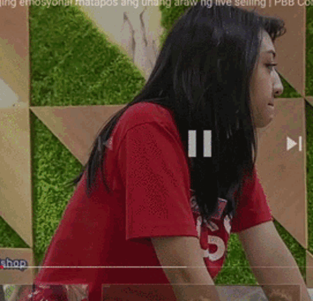 a woman in a red shirt with the number 15 on her shirt