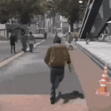 a man is running down a street in a video game while people walk down the sidewalk .