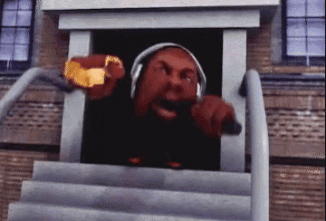 a man wearing headphones and a gold ring is standing on stairs